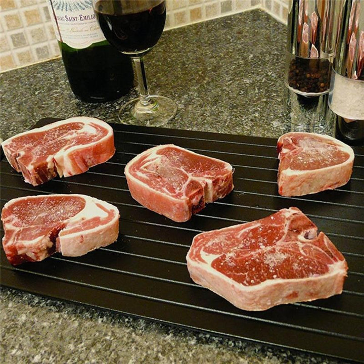 Fünf rohe Rindersteaks auf schwarzem Schneidebrett, Küche, Fleischzubereitung, Gourmet.