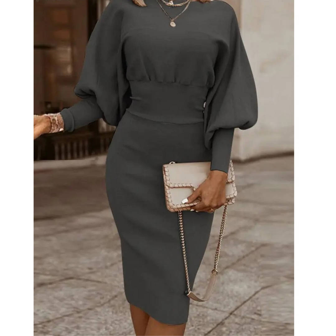 Frau in grauem Cocktailkleid mit Laternenärmeln und Clutch, elegantes Abendoutfit.