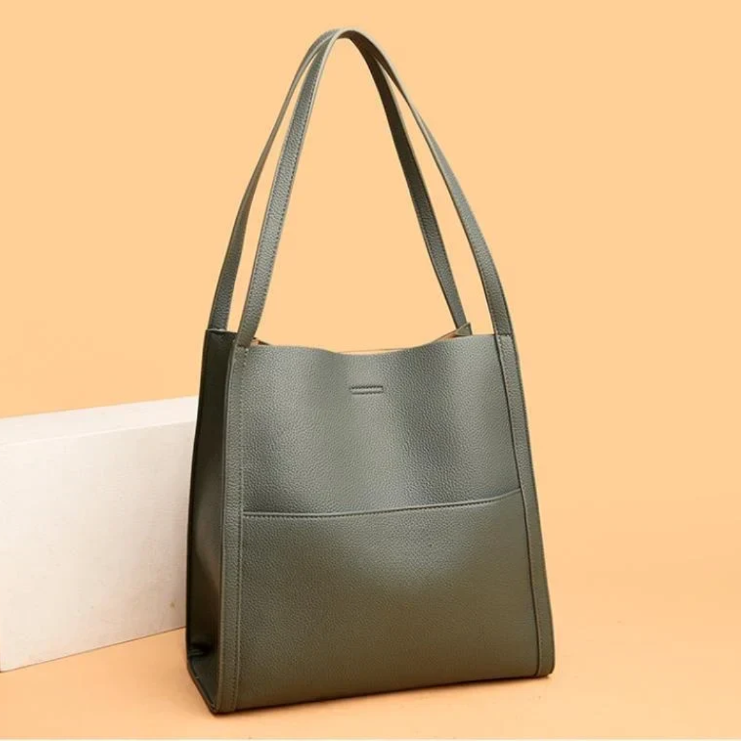 Grüne Ledertasche mit langen Henkeln, elegantes Design, Damenhandtasche, modisch.