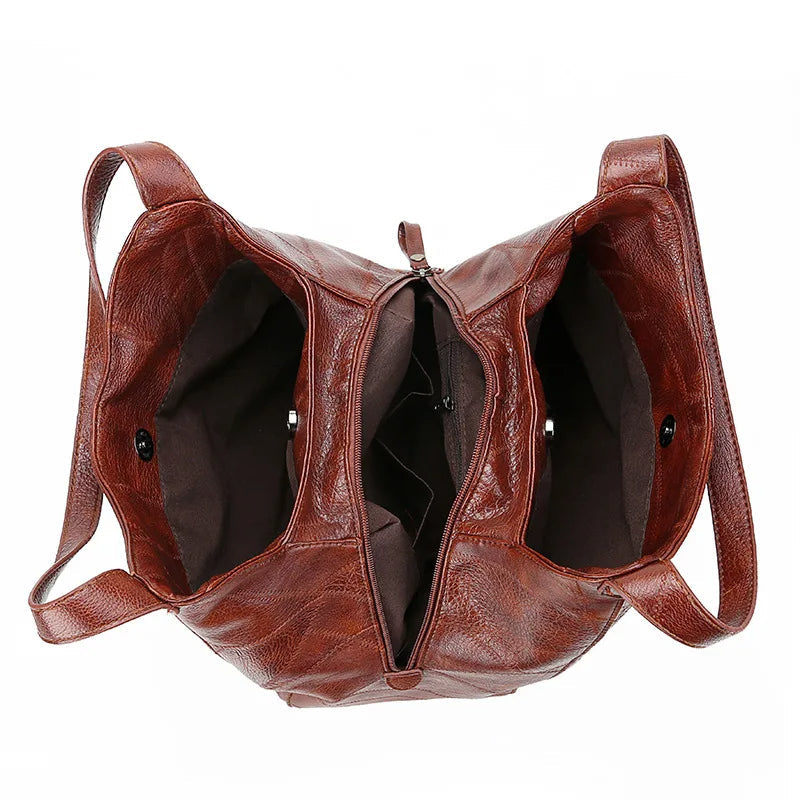 Braune Lederhandtasche mit zwei Fächern, Reißverschluss, modisch, Damenaccessoire.