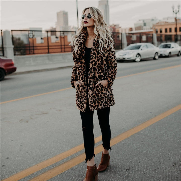 Frau in Leopardenmantel, schwarze Jeans, braune Stiefel, Stadtstraße, modisch, urbaner Stil.