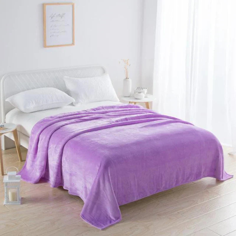 Lila Fleecedecke auf weißem Bett, Schlafzimmer, gemütlich, weich, Heimtextilien, modern.