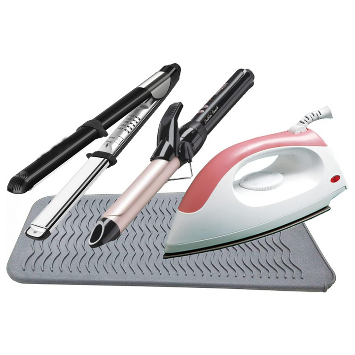 Lockenstäbe und Bügeleisen auf grauer Silikonmatte, Haarstyling und Bügelzubehör.