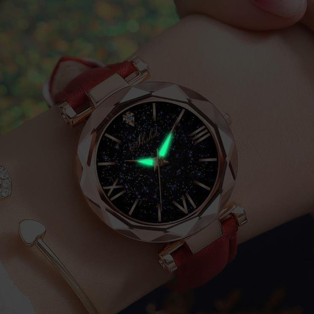 Luxus Damenarmbanduhr mit rotem Lederarmband, leuchtendem Zifferblatt, römischen Ziffern.