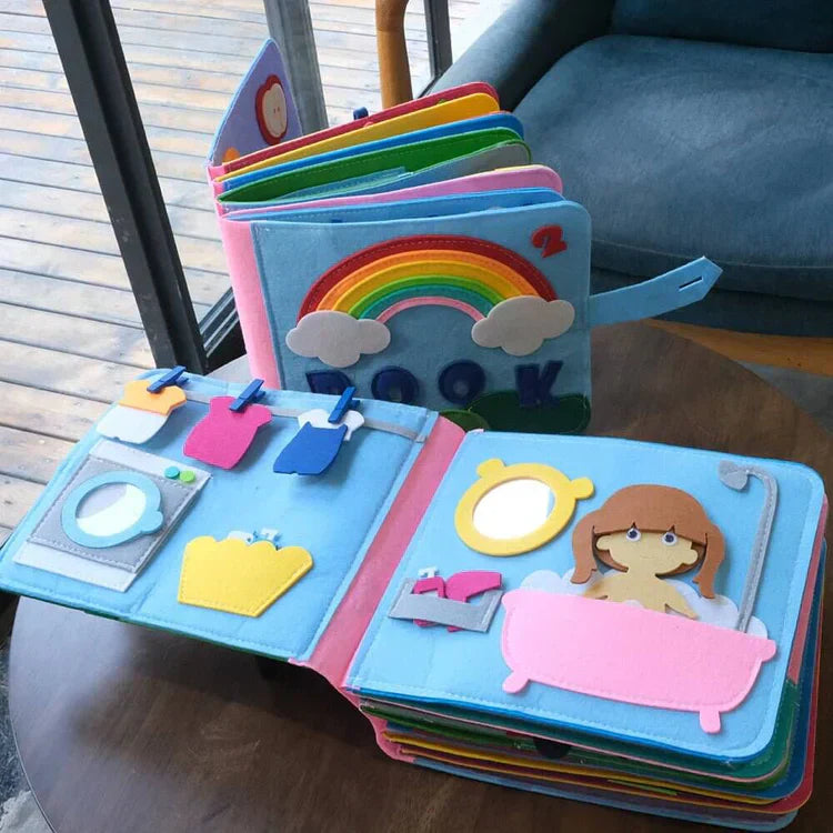 Montessori Stoffbuch für Kinder, bunt, interaktiv, Lernspielzeug, pädagogisch, Regenbogenmotiv.