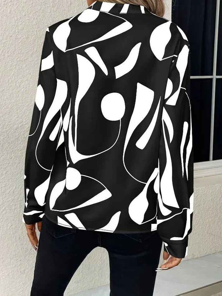 Schwarze Bluse mit weißem abstraktem Muster, Damenmode, Langarm, elegant, modern.