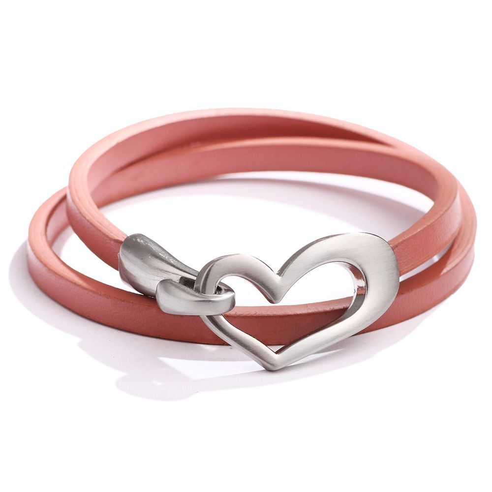 Rosa Lederarmband mit Herzverschluss aus Edelstahl, modisches Schmuckaccessoire.