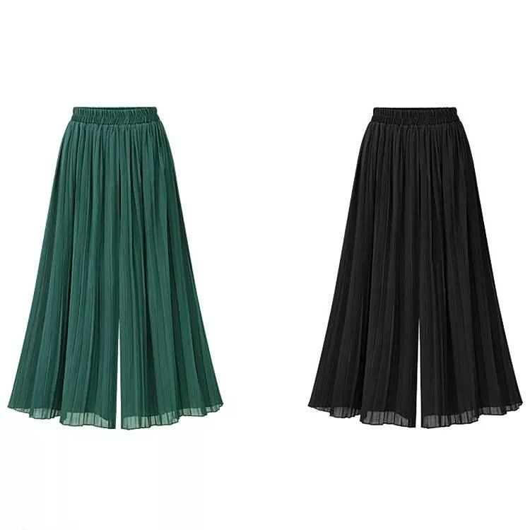 Grüne und schwarze plissierte Damenhosen, weit geschnitten, elegant, modisch, aus leichtem Stoff.