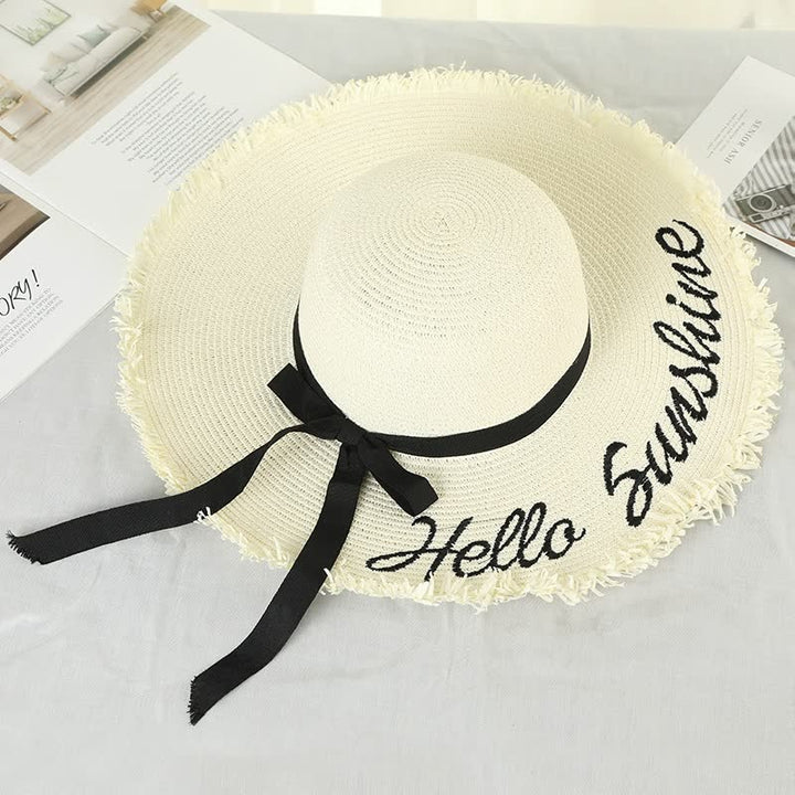 Weißer Strohhut mit schwarzer Schleife und "Hello Sunshine"-Schriftzug, Sommermode Accessoire.