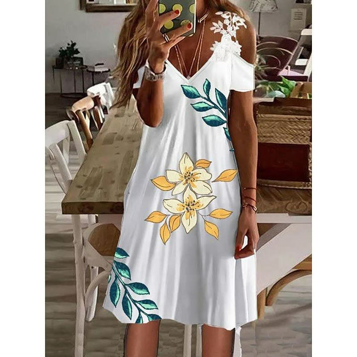 Frau in weißem Sommerkleid mit Blumenmuster, V-Ausschnitt, schulterfrei, im Wohnzimmer.