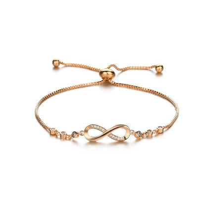 Goldenes Armband mit Unendlichkeitssymbol, verstellbar, mit Zirkonia-Steinen, elegantes Schmuckstück.