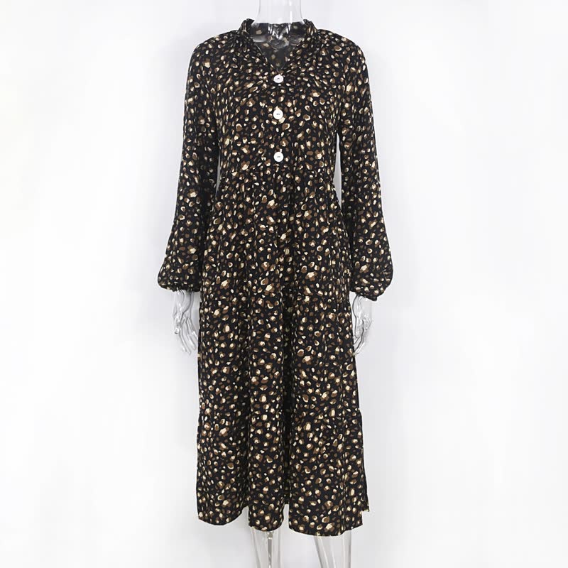 Schwarzer Damen-Jumpsuit mit weißen Punkten, lange Ärmel, Knopfleiste, modisch, elegant.