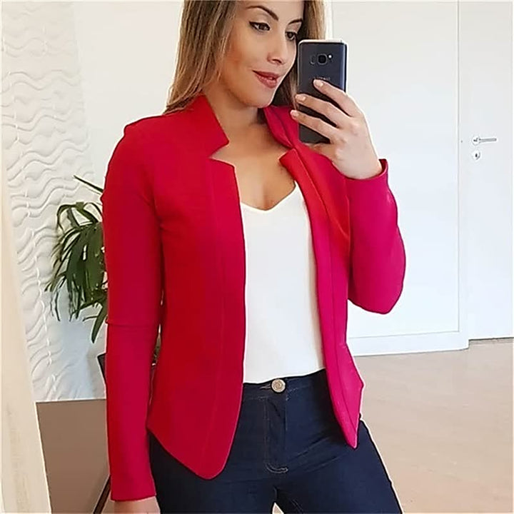 Frau in rotem Blazer, weißem Top, dunkler Jeans, Selfie, moderne Damenmode, stilvoll.