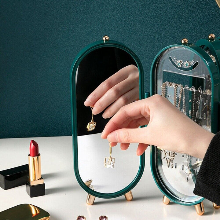 Grüner Schmuck-Organizer mit Spiegel, Ohrringe, Lippenstift, elegantes Design, Schmuckaufbewahrung.