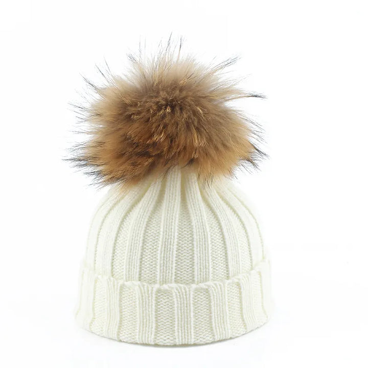 Weiße Strickmütze mit braunem Kunstfellbommel, Wintermode Accessoire, warm und stilvoll.
